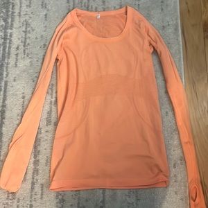 orange pink colored lululemon swifly tech no flaws at all only used a few times